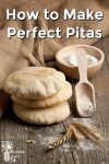 Pitas by a bowl of flour and a scoop