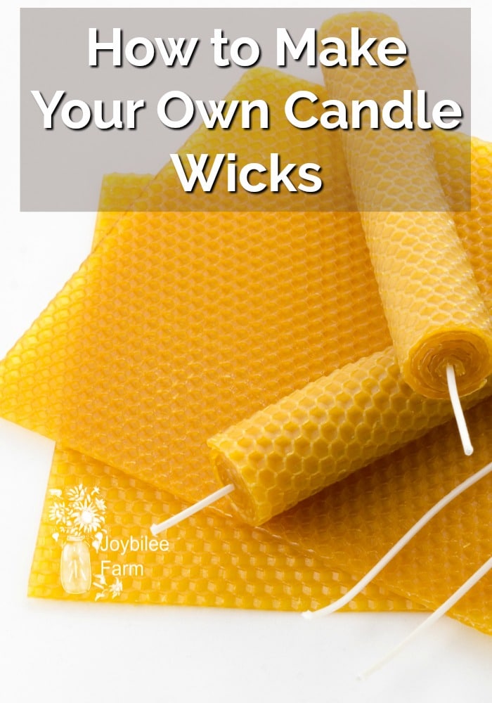 Beeswax candles and candle wicks sitting on beeswax sheets