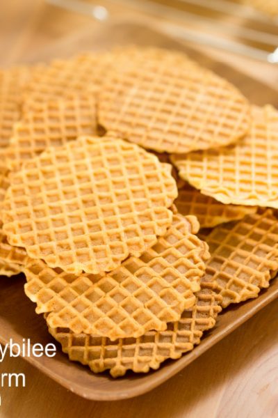 finished pizzelles on a brown serving tray