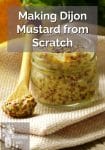 Glass jar of dijon mustard