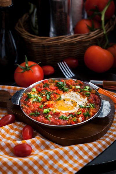 Egg dish with tomatoes freshly cooked in a pan