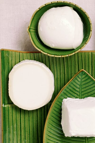 White cheese on green decorative plates
