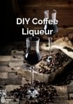 Two flutes of coffee liqueur with coffee beans scattered all around
