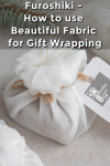 Christmas presents wrapped with white furoshiki fabric