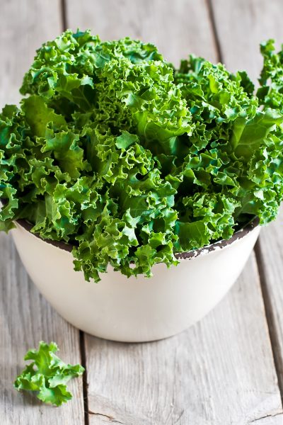 Fresh green kale in a white bowl