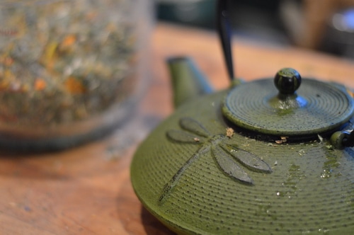 tea pot and a mason jar of homemade tea leaves