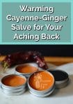 Tins of cayenne salve by a red cayenne pepper