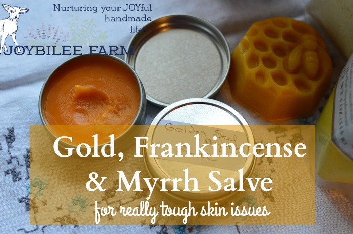 freshly made gold, frankincense, and myrrh salve on a white background