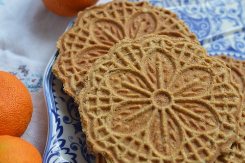 Pizzelles are an Italian wafer cookie made with a special iron press that squishes the cookie batter between two decorative plates, and then heats it to a crisp cookie texture, much like a waffle cone. Pizzelles are quick to make, and not too sweet. Commonly served with espresso they are a light treat that won’t overwhelm.
