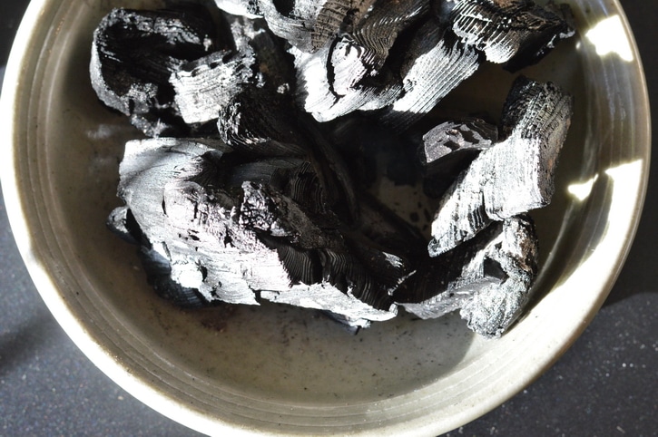 Charcoal in a clay dish.