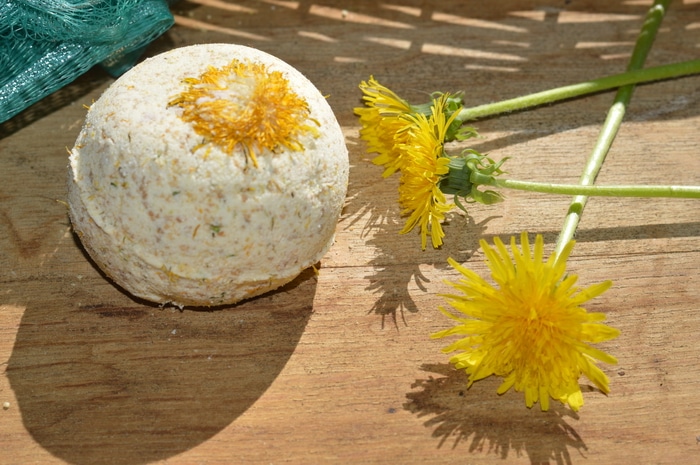 dandelion flowers with a bath bomb - Use these dandelion bath bombs when you need relief for achy muscles and sore joints.