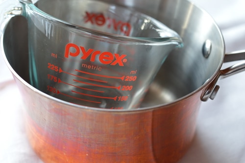 Stock pot with a glass measuring cup inside