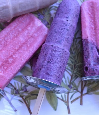 Homemade blueberry popsicles on a plate