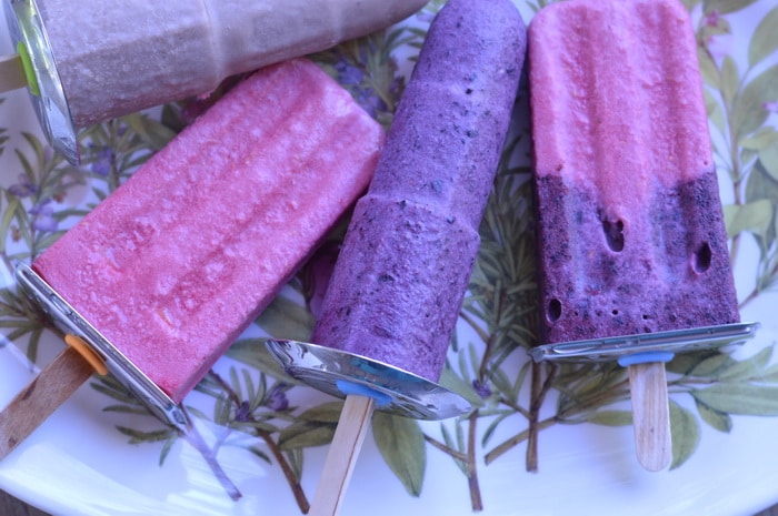 Homemade blueberry popsicles on a plate