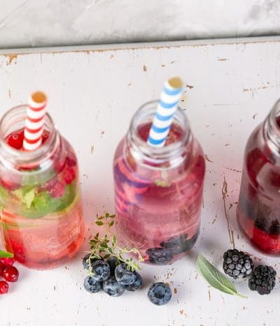 Drinking vinegars in glass bottles with colourful straws