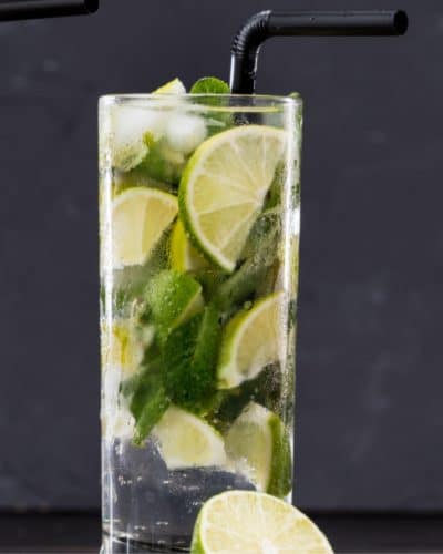 glasses of fresh herbs and seltzer with herb simple syrup