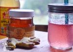 ginger, honey, and vinegar on a table with a jar of switchel