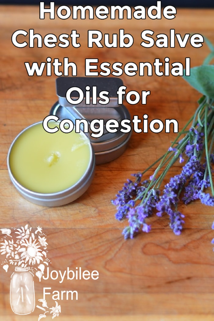 Prepared salve with essential oils for congestion on a wooden board with fresh lavender beside it.