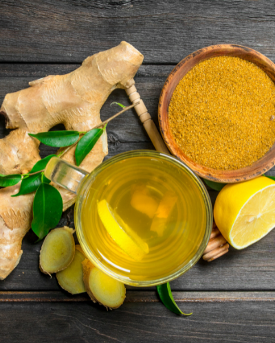 lemon, ginger, and turmeric tea ingredients on a dark wooden background