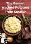 mashed potatoes in a brown bowl on a brown background with dill leaves