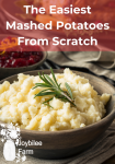 mashed potatoes in a grey bowl with rosemary on top, background cranberry sauce and roast turkey