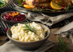 holiday layout of mashed potatoes from scratch, cranberry dressing, and background turkey