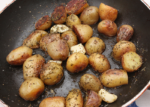 roasted potatoes in a pan sprinkled with an herb blend