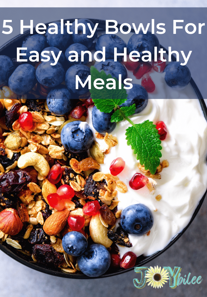 a healthy bowl with yogurt, blue berries, and granola.